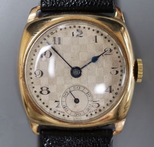 A gentlemans early 1930s 9ct gold manual wind wrist watch, with checkered dial, on later strap.
